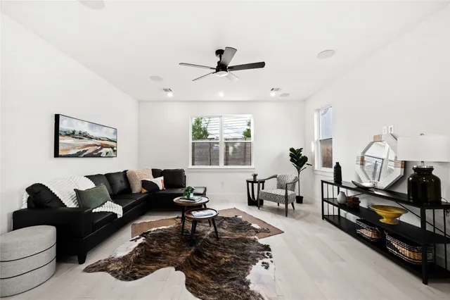 a living room with furniture windows and a flat screen tv