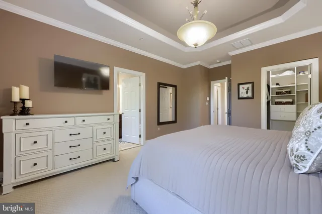 a bedroom with a large bed and a tv