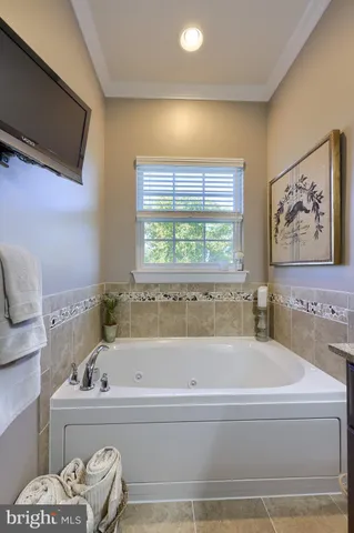 a bathroom with a bathtub and a window
