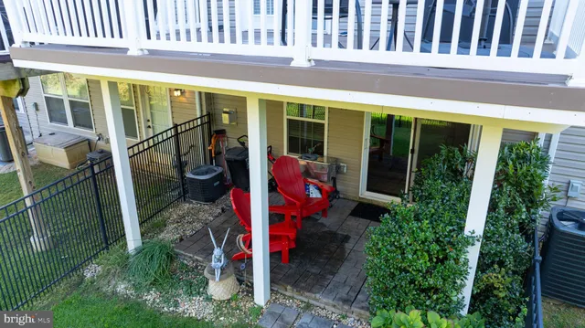 a view of a house with a deck and a yard