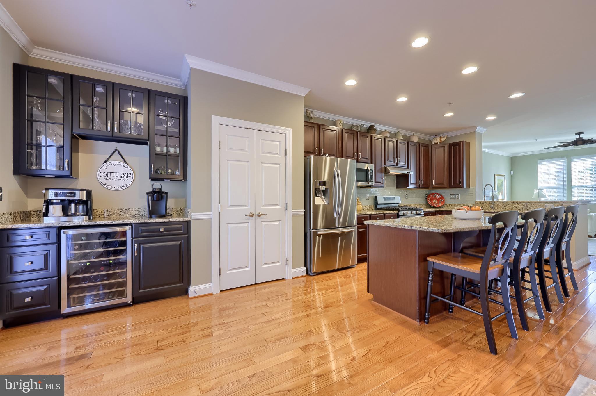 938 Stonehaven Way York, PA 17403 - Photo 7 of 45 a kitchen with stainless steel appliances kitchen island granite countertop a refrigerator and wooden cabinets