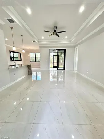 a lobby with furniture and a ceiling fan
