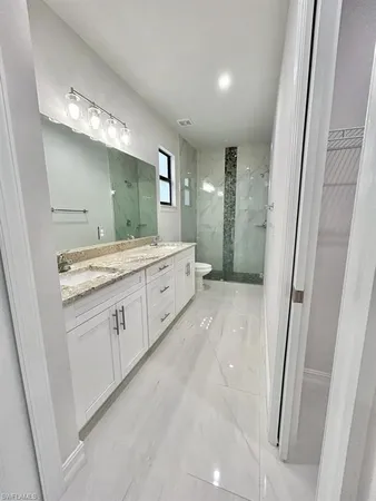 a bathroom with a double vanity sink and mirror