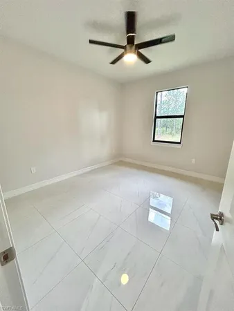 a bathroom with a granite countertop sink toilet and a mirror