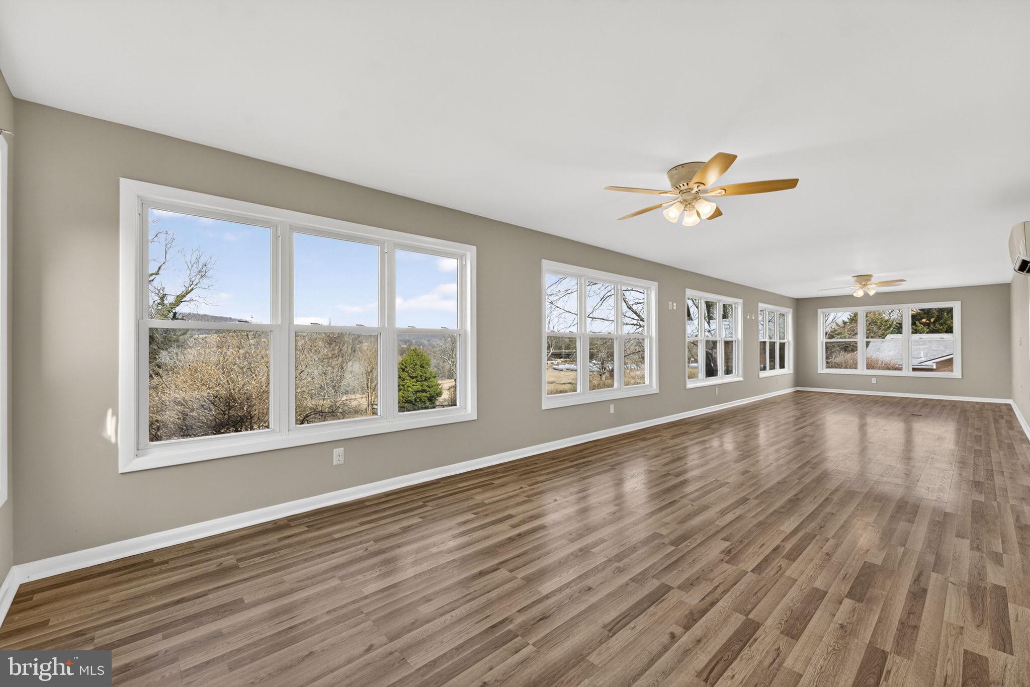 660 Foxcroft Road Warrenton, VA 20186 - Photo 11 of 24 a view of an empty room with a window and wooden floor