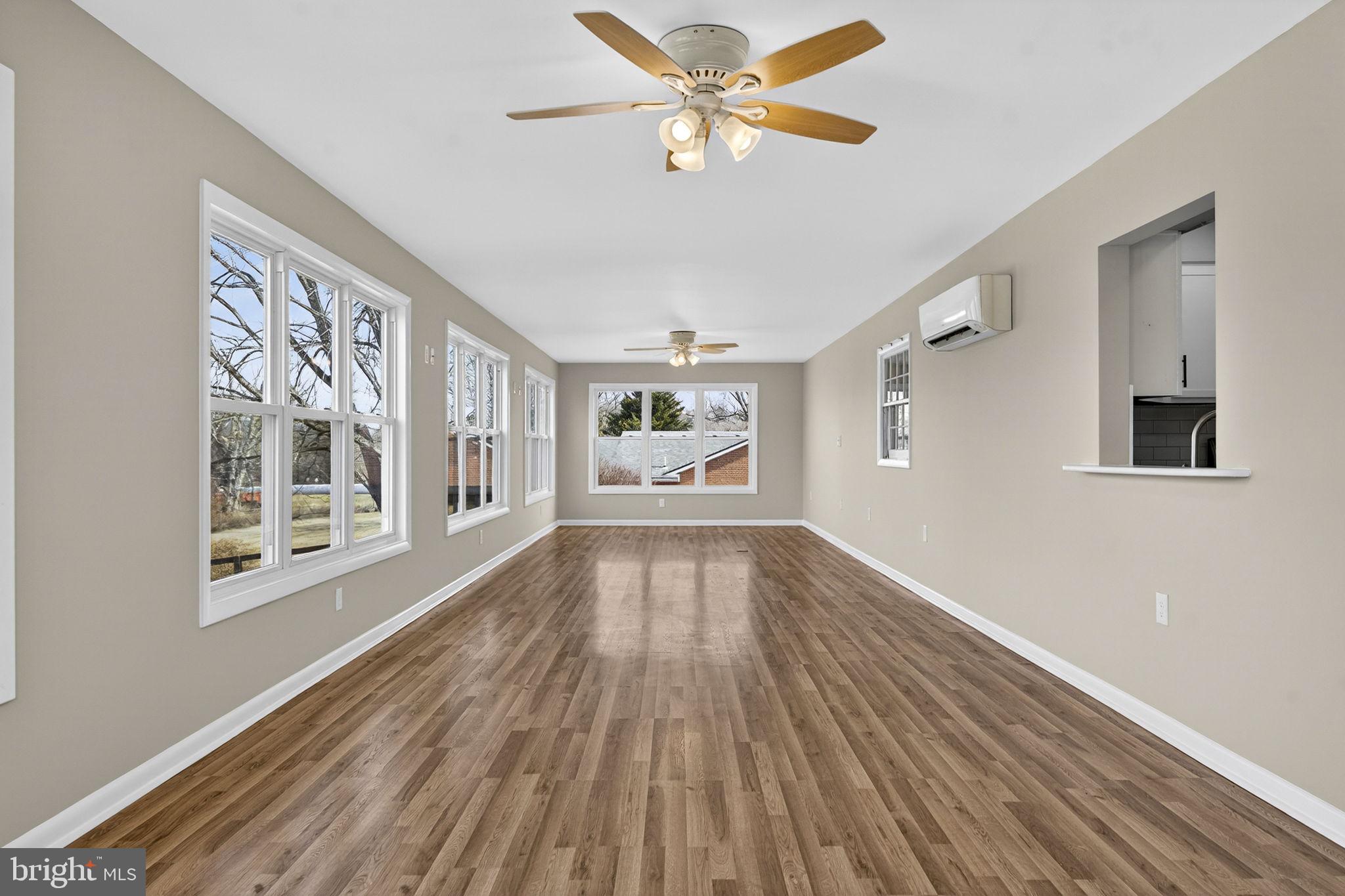 660 Foxcroft Road Warrenton, VA 20186 - Photo 12 of 24 a view of an empty room with a window and wooden floor