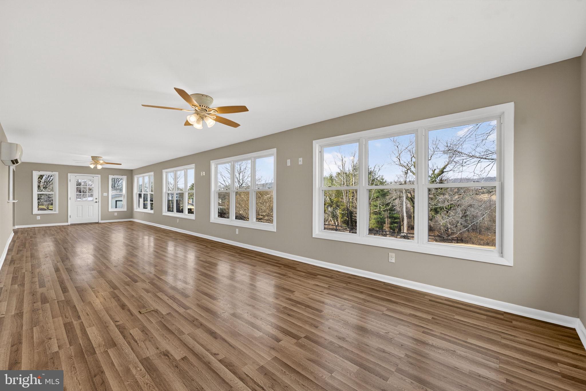 660 Foxcroft Road Warrenton, VA 20186 - Photo 14 of 24 a view of an empty room with wooden floor and a window