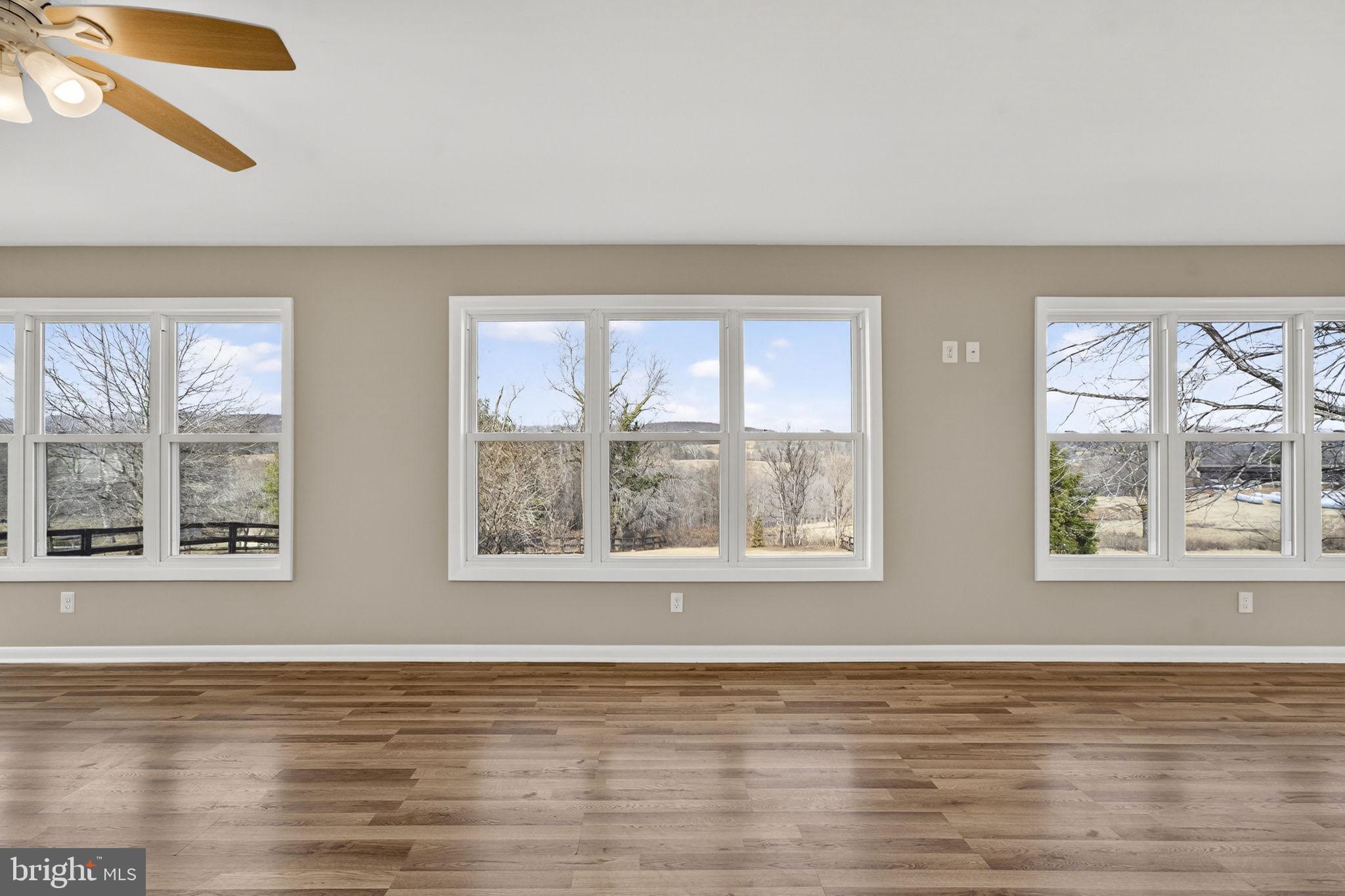 660 Foxcroft Road Warrenton, VA 20186 - Photo 15 of 24 a view of an empty room with wooden floor and a window