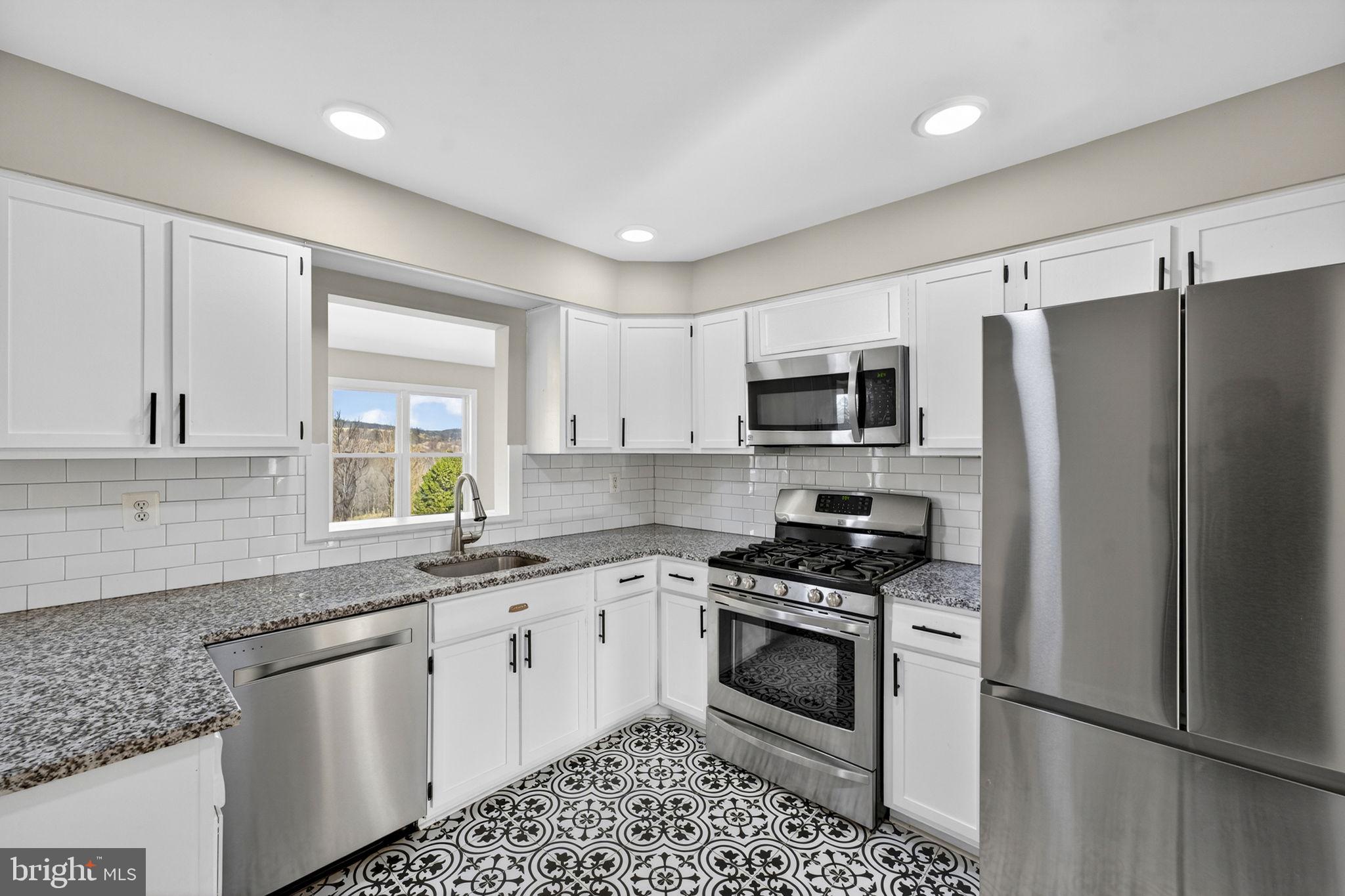 660 Foxcroft Road Warrenton, VA 20186 - Photo 4 of 24 a kitchen with a sink stove and refrigerator