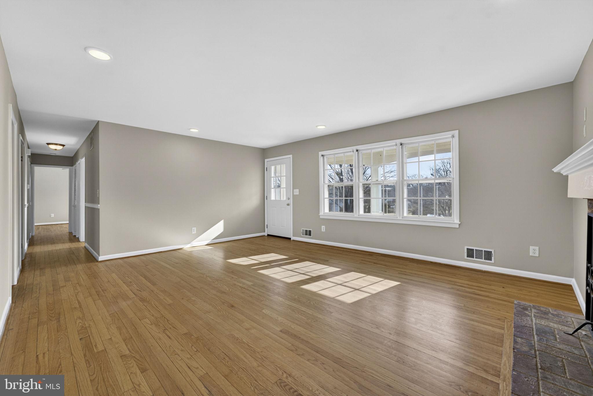 660 Foxcroft Road Warrenton, VA 20186 - Photo 7 of 24 a view of an empty room with window and wooden floor