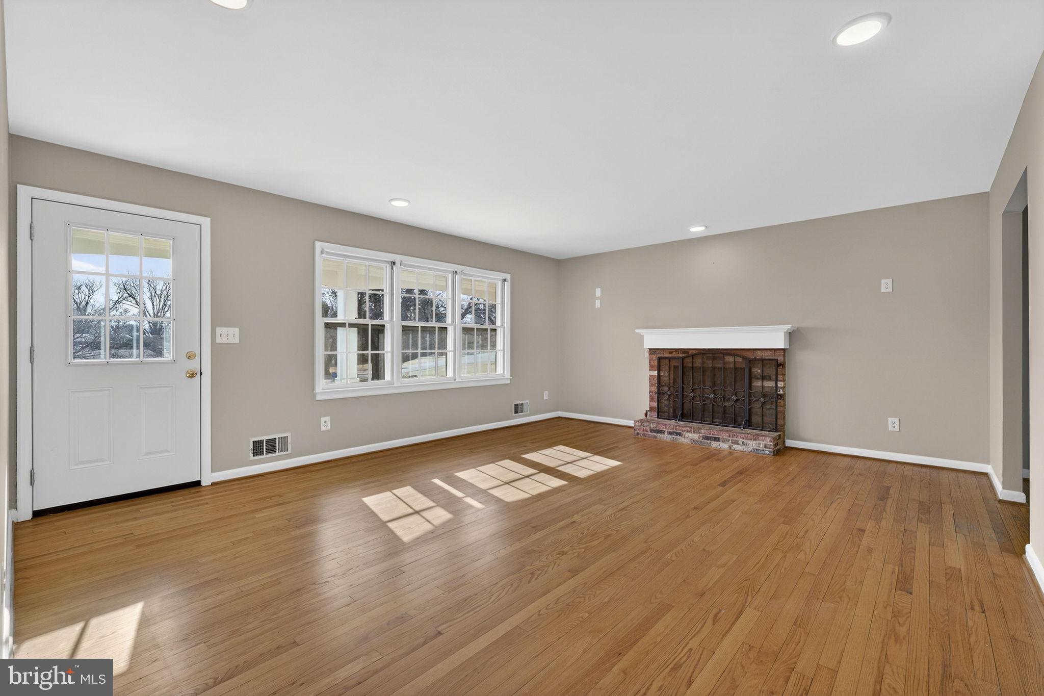 660 Foxcroft Road Warrenton, VA 20186 - Photo 9 of 24 a view of empty room with wooden floor and fireplace