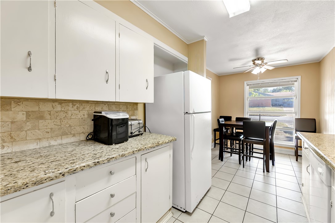 520 Helena Street Bryan, TX 77801 - Photo 12 of 25 a kitchen with granite countertop cabinets and refrigerator