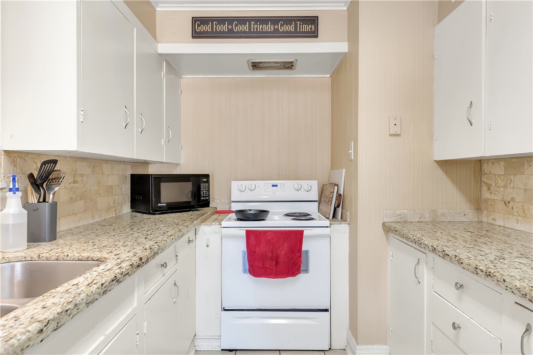 520 Helena Street Bryan, TX 77801 - Photo 10 of 25 a kitchen with a stove and a sink