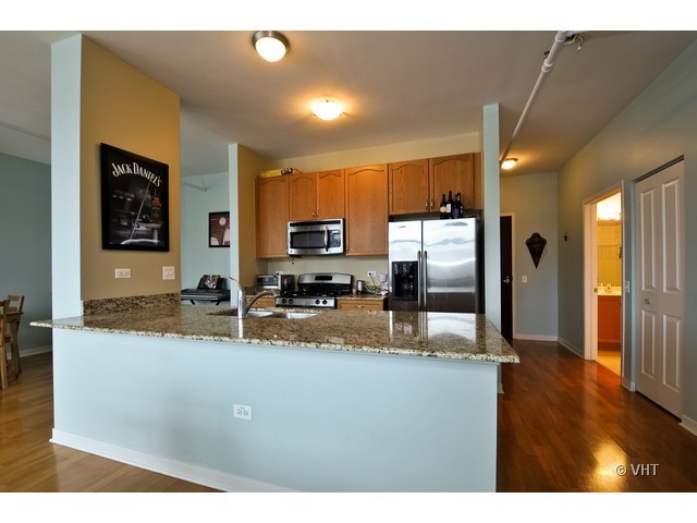 511 West Division Street, Unit 312 Chicago, IL 60610 - Photo 4 of 10 a kitchen with stainless steel appliances granite countertop a refrigerator a stove and a sink
