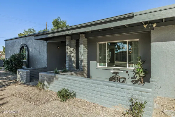 a front view of a house with outdoor seating