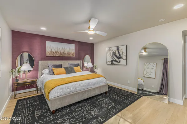 a bedroom with bed and wooden floor