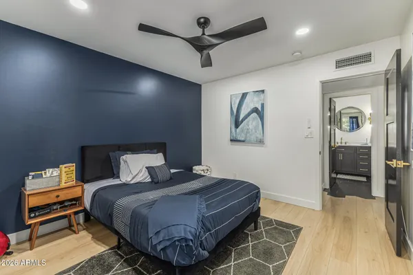 a bedroom with a bed and a chandelier