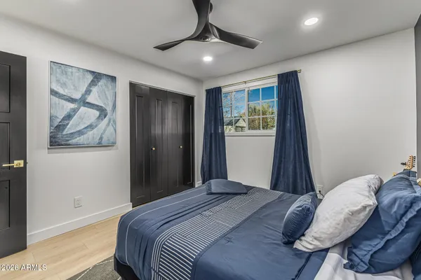 a bedroom with a bed and a chandelier