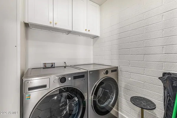 a patio with a table chairs and a yard