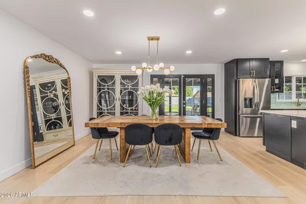 a view of a dining room with furniture and chandelier