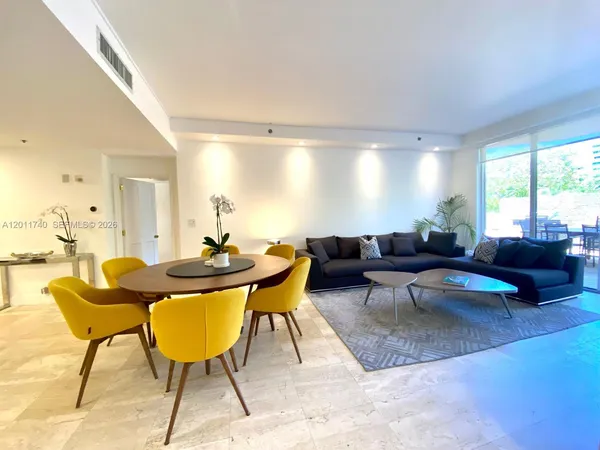 a living room with furniture a rug and a large window