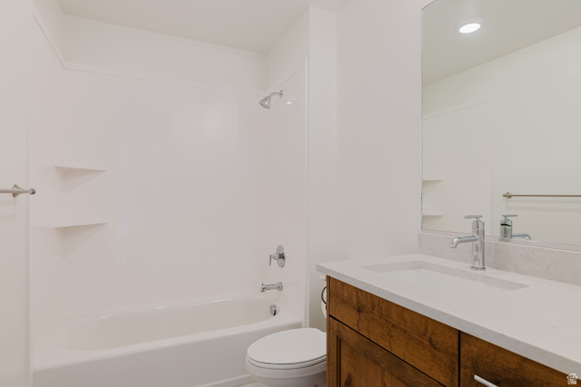433 North 600 West Smithfield, UT 84335 - Photo 26 of 40 Bathroom featuring a white tub/shower combination with built-in shelving, a wood-finish vanity with a white countertop and integrated sink, and a large wall-mounted mirror