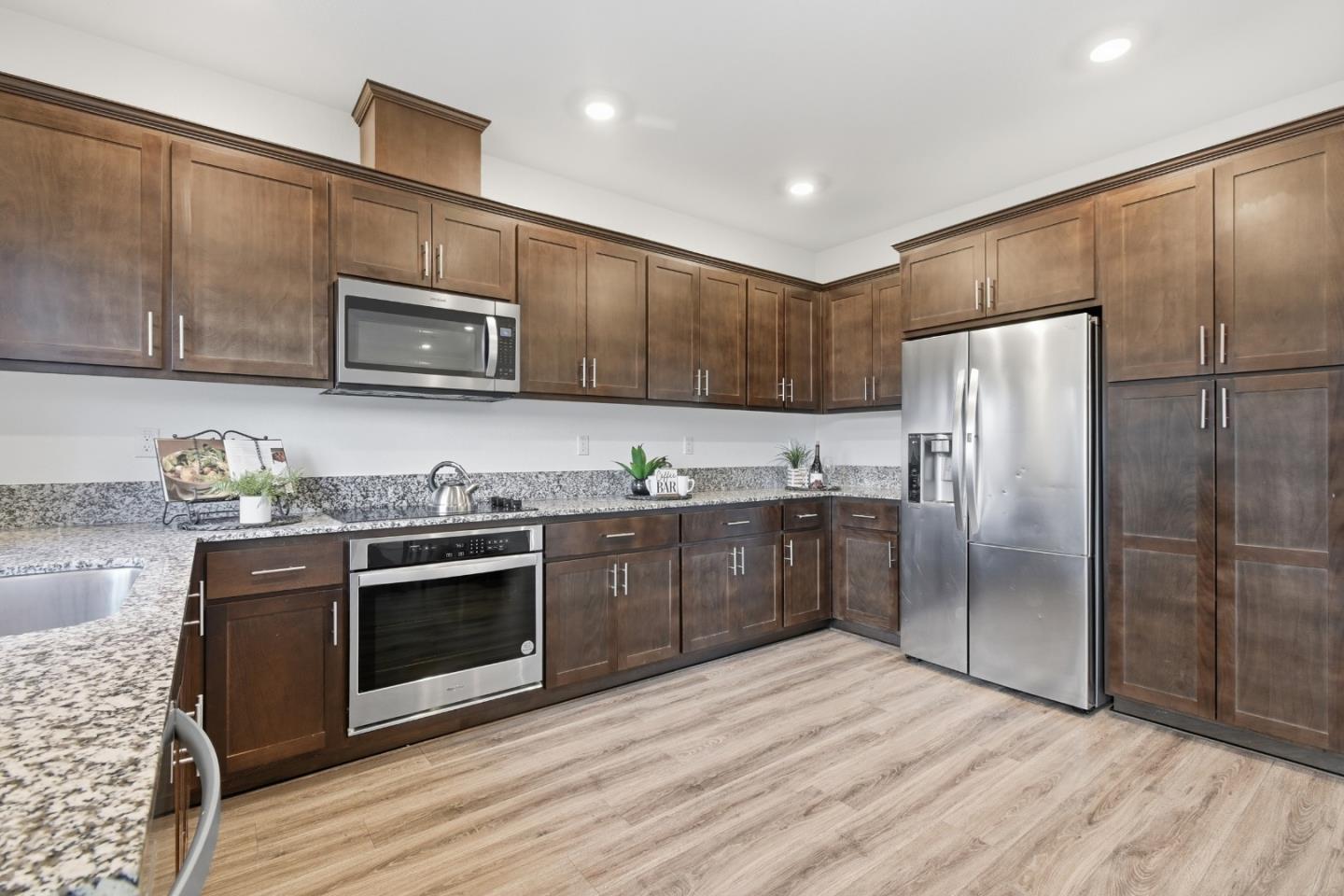 121 Mountaintop Avenue Hayward, CA 94544 - Photo 11 of 38 a kitchen with stainless steel appliances granite countertop a refrigerator microwave and stove