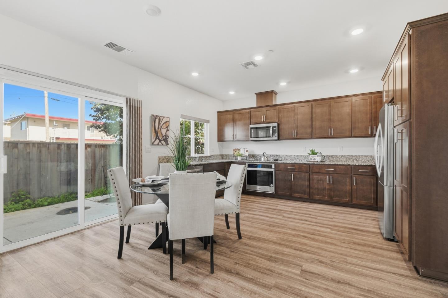121 Mountaintop Avenue Hayward, CA 94544 - Photo 13 of 38 a kitchen with a table chairs refrigerator and cabinets