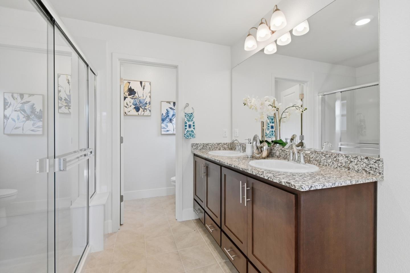 121 Mountaintop Avenue Hayward, CA 94544 - Photo 20 of 38 a bathroom with a granite countertop sink a light fixture and a mirror