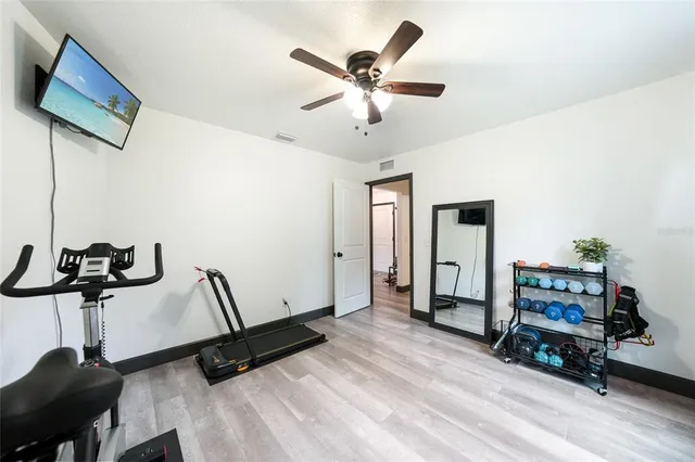 a aerial view of a house with yard and green space