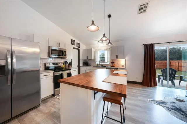 a living room with furniture or kitchen and a wooden floor