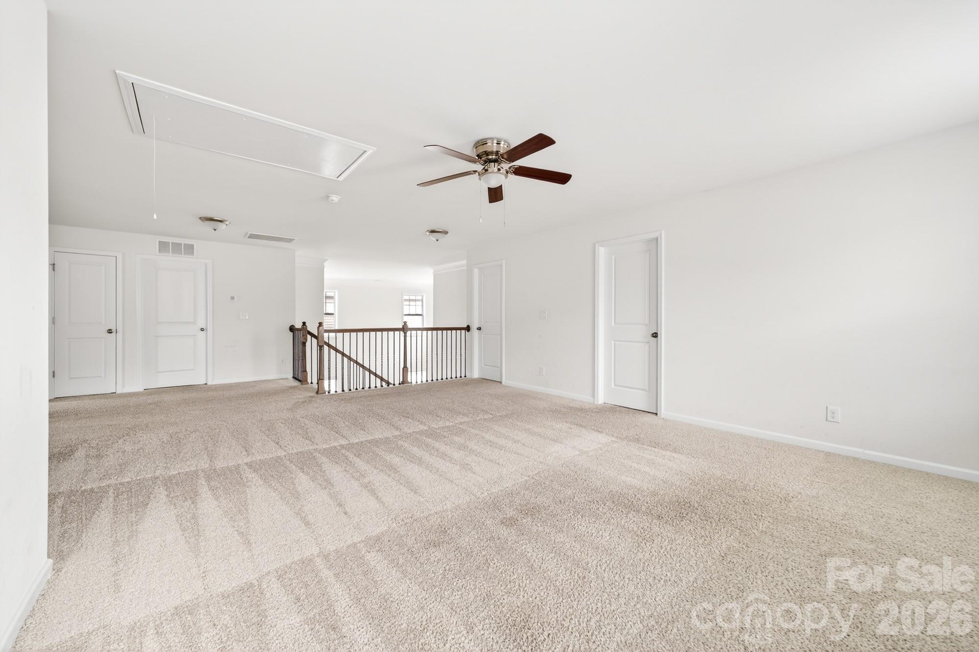 5972 Redwood Pine Road Concord, NC 28027 - Photo 22 of 37 an empty room with chandelier fan and windows