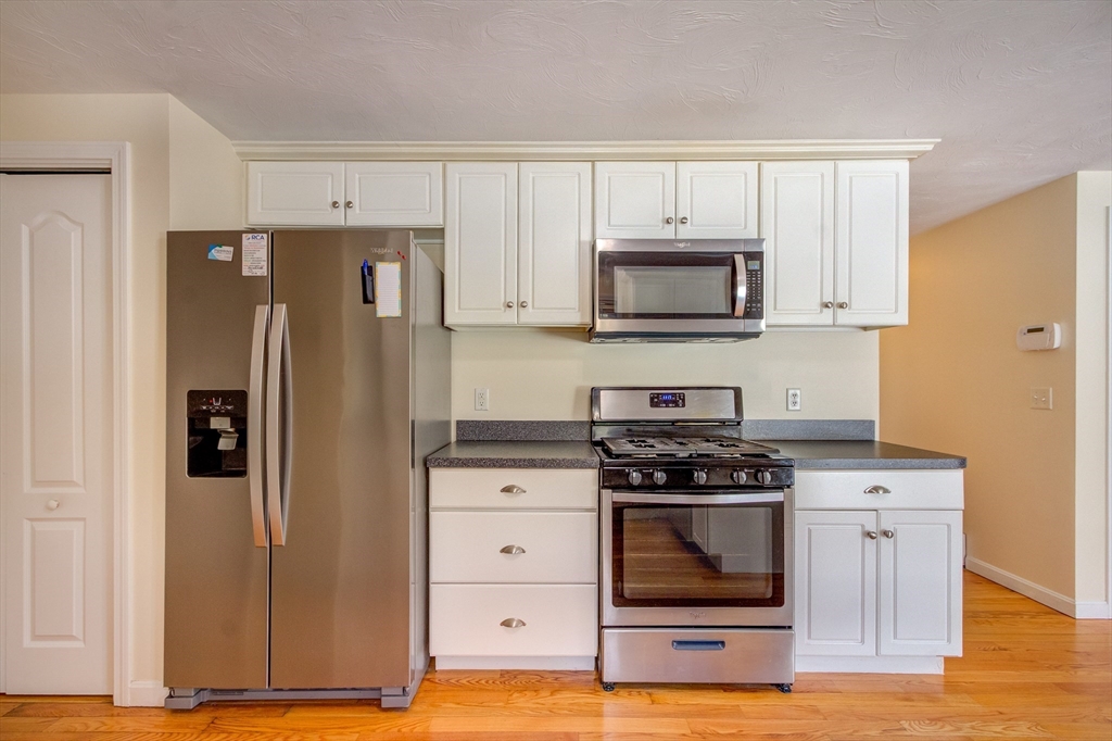 17 Lynne Road Wareham, MA 02571 - Photo 12 of 42 a kitchen with granite countertop a stove and a refrigerator