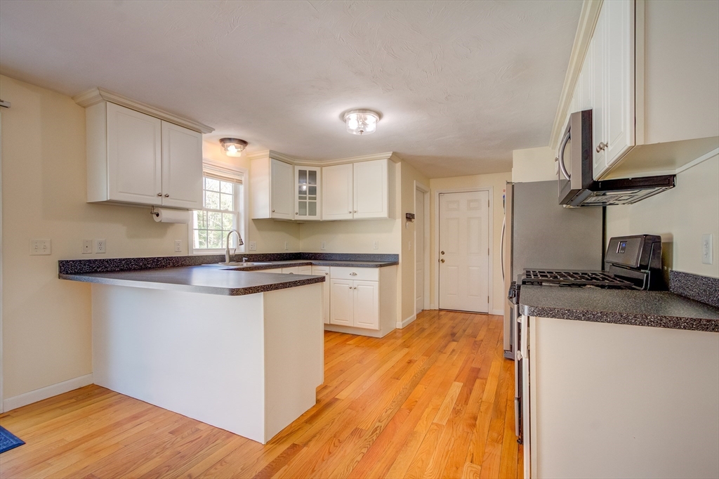 17 Lynne Road Wareham, MA 02571 - Photo 14 of 42 a kitchen with granite countertop a sink stainless steel appliances and cabinets