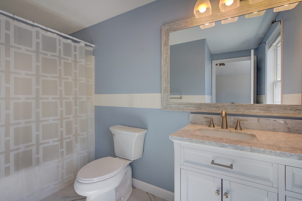 17 Lynne Road Wareham, MA 02571 - Photo 30 of 42 a bathroom with a toilet sink and mirror