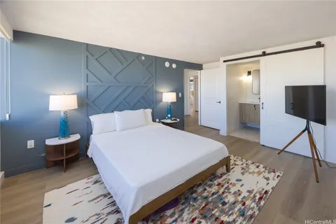 a bedroom with a bed and a mirror