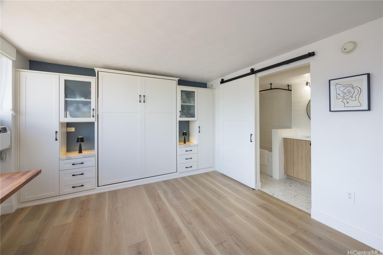 343 Hobron Lane, Unit 3901 Honolulu, HI 96815 - Photo 16 of 25 an empty room with closet and wooden floor