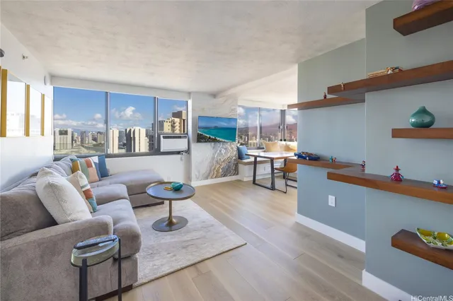 a living room with furniture and a wooden floor