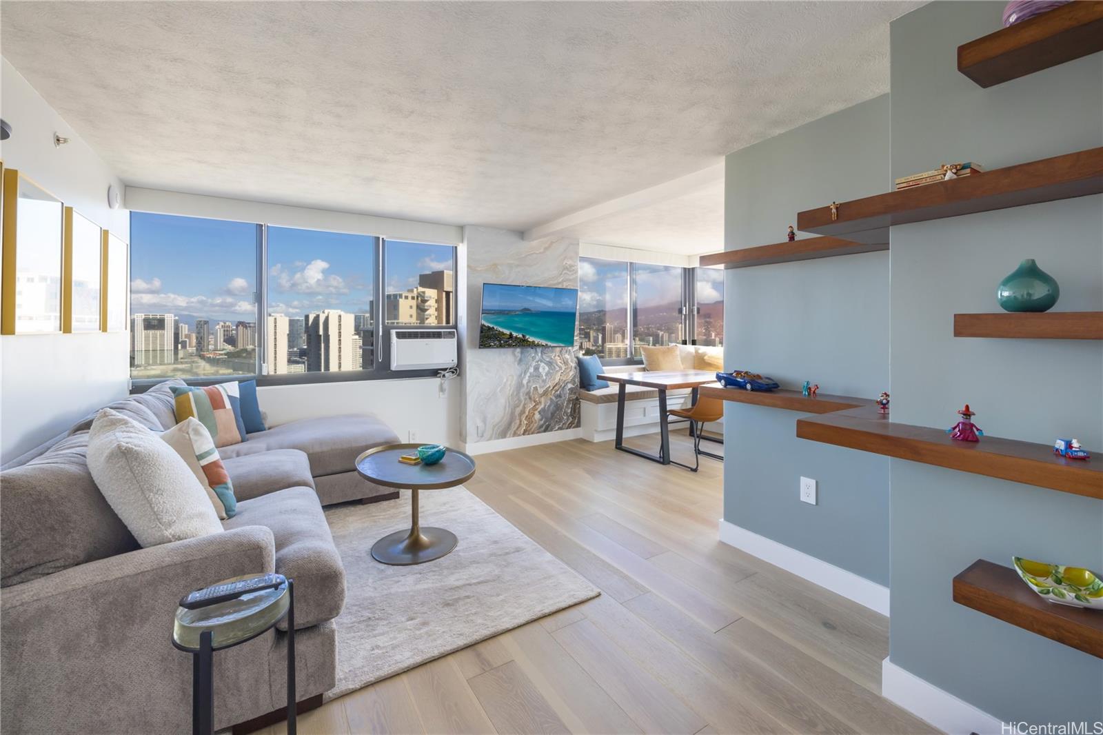 343 Hobron Lane, Unit 3901 Honolulu, HI 96815 - Photo 2 of 25 a living room with furniture and a wooden floor