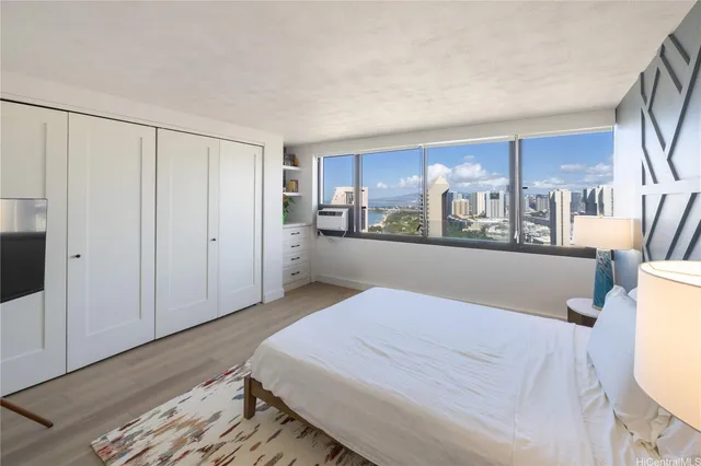 a bed room with a bed and a view of kitchen