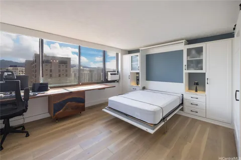 a bedroom with a large bed and a large window
