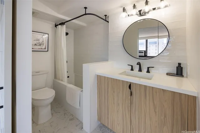 a bathroom with a sink mirror and toilet