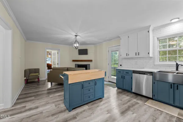 a kitchen with stainless steel appliances granite countertop a refrigerator sink and cabinets
