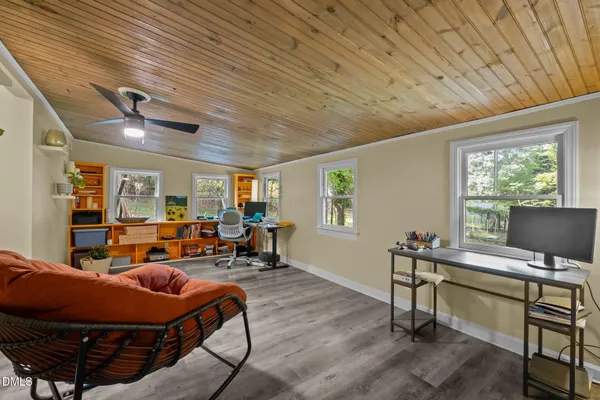 a large kitchen with cabinets wooden floor and stainless steel appliances