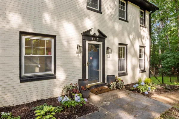 a front view of a house with a garden