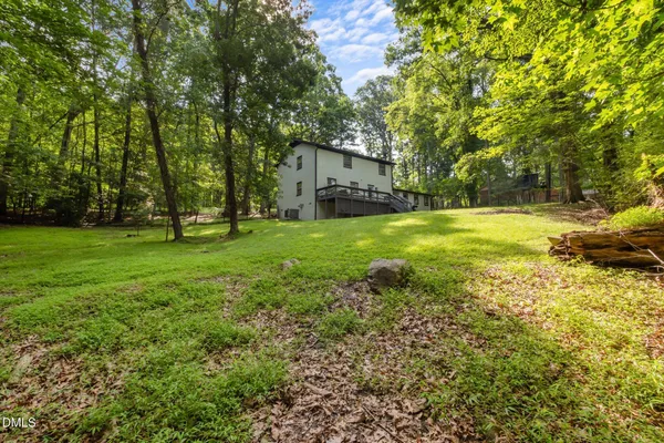 a view of a backyard with a garden and trees
