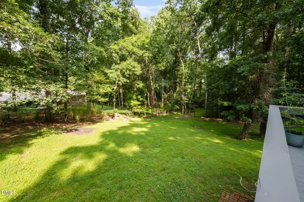 a view of a backyard with large trees