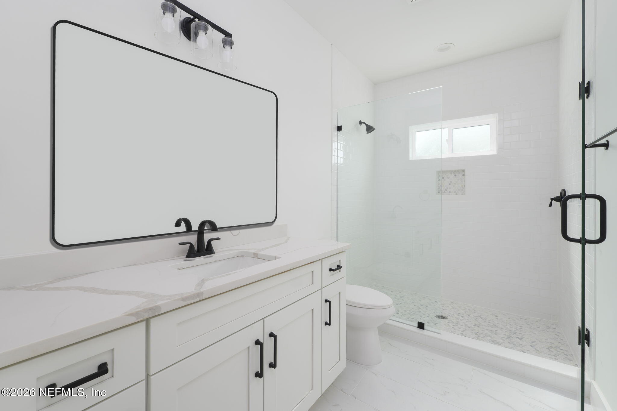 213 Twenty-First Street St. Augustine, FL 32084 - Photo 11 of 50 a bathroom with a granite countertop sink a toilet and a mirror