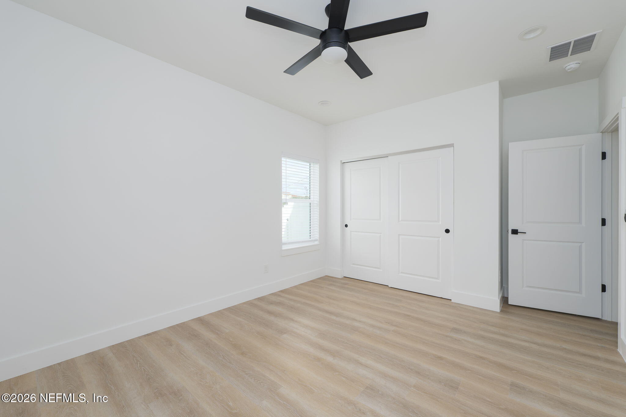 213 Twenty-First Street St. Augustine, FL 32084 - Photo 13 of 50 a view of a room with wooden floor and ceiling fan