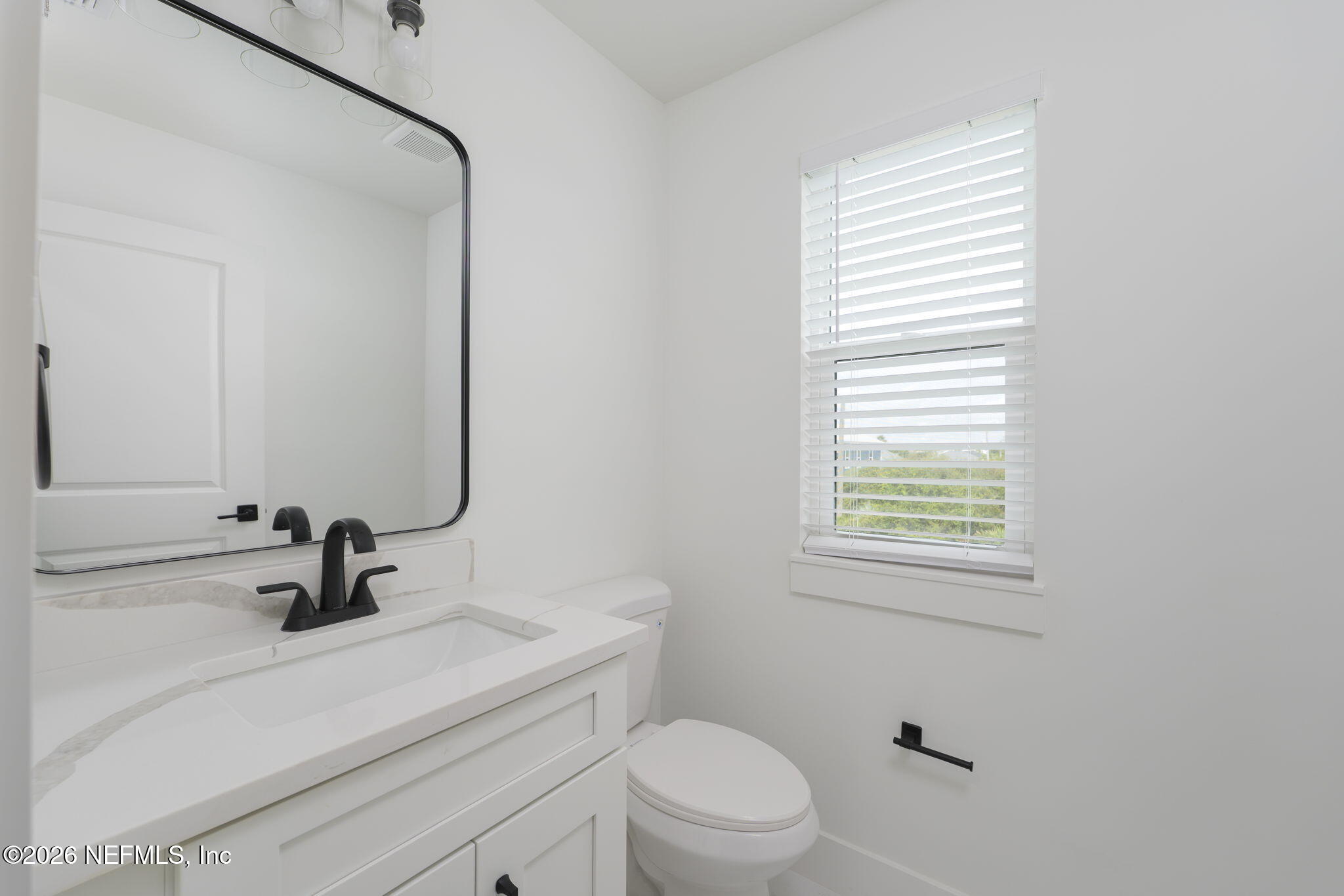 213 Twenty-First Street St. Augustine, FL 32084 - Photo 21 of 50 a bathroom with a sink a toilet and a window